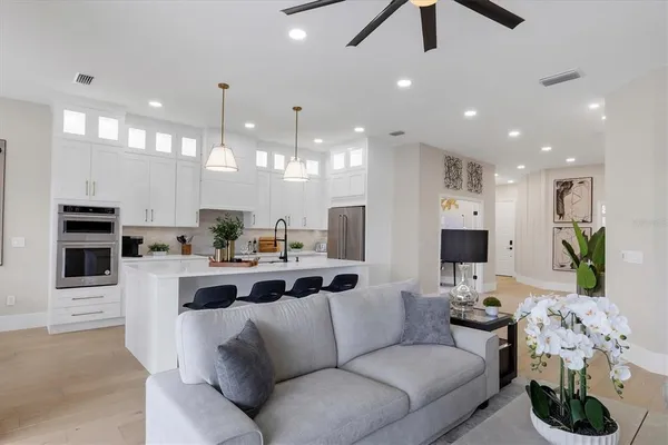 a kitchen with kitchen island granite countertop a sink cabinets and stainless steel appliances