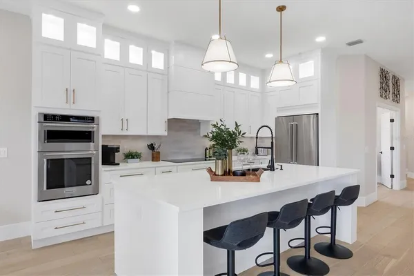 a kitchen with refrigerator and cabinets