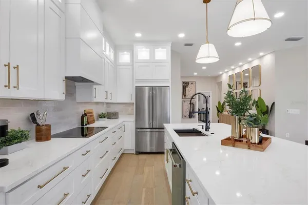 a kitchen with granite countertop a white cabinets and window