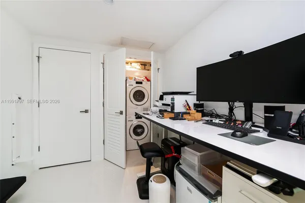 a view of a workspace with furniture and washer