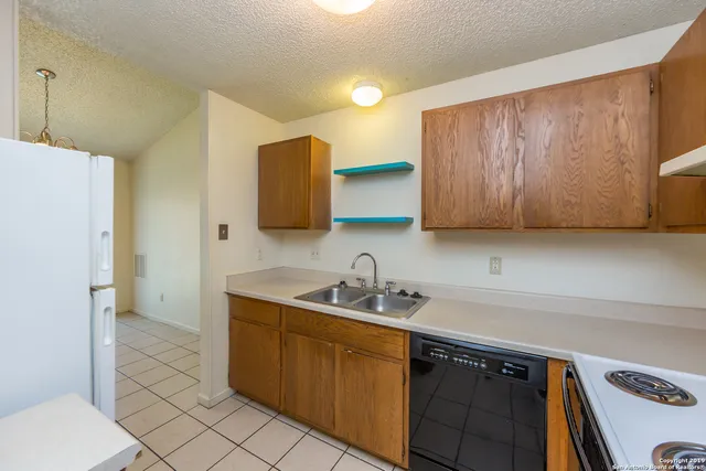 a kitchen with a sink cabinets and appliances