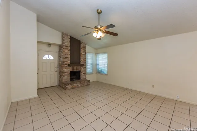 a view of an empty room and fire place