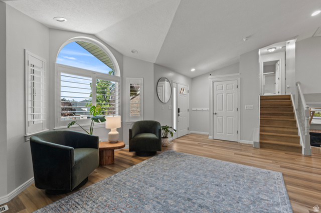 1557 Braxton Place Logan, UT 84321 - Photo 5 of 46 Vaulted ceiling entry with wood-finish flooring, plantation shutters, arched window, and recessed lighting