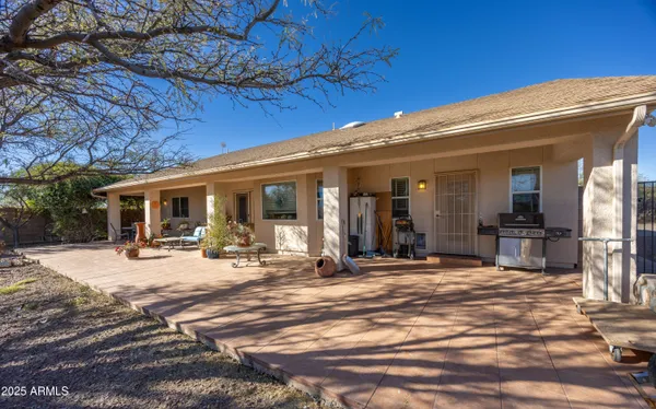 a view of a house with backyard porch and sitting area