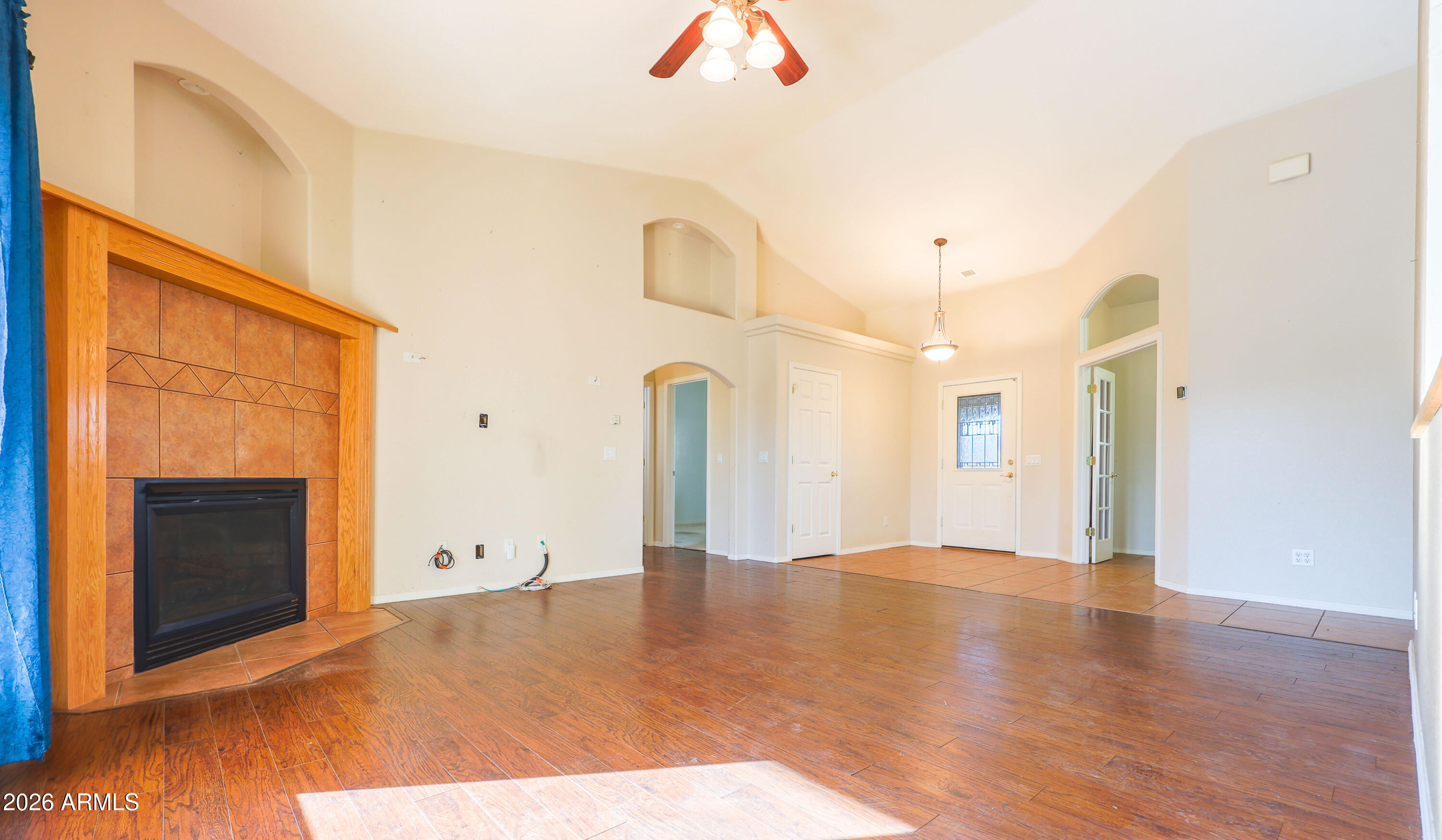 10148 South Airstrip Road Hereford, AZ 85615 - Photo 8 of 36 a view of an empty room with wooden floor and a fireplace