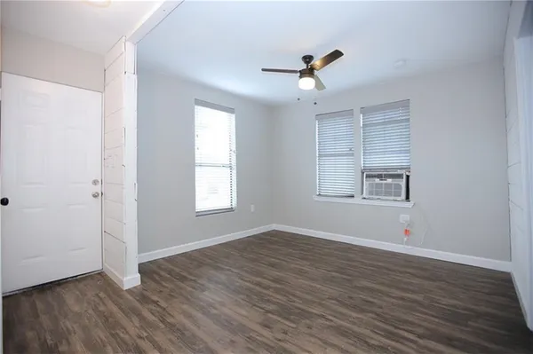 wooden floor in an empty room with a window