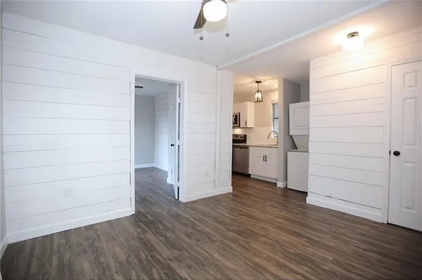 wooden floor in an empty room with a kitchen