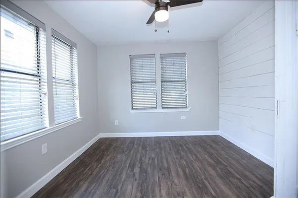 a view of wooden floor and windows in a room