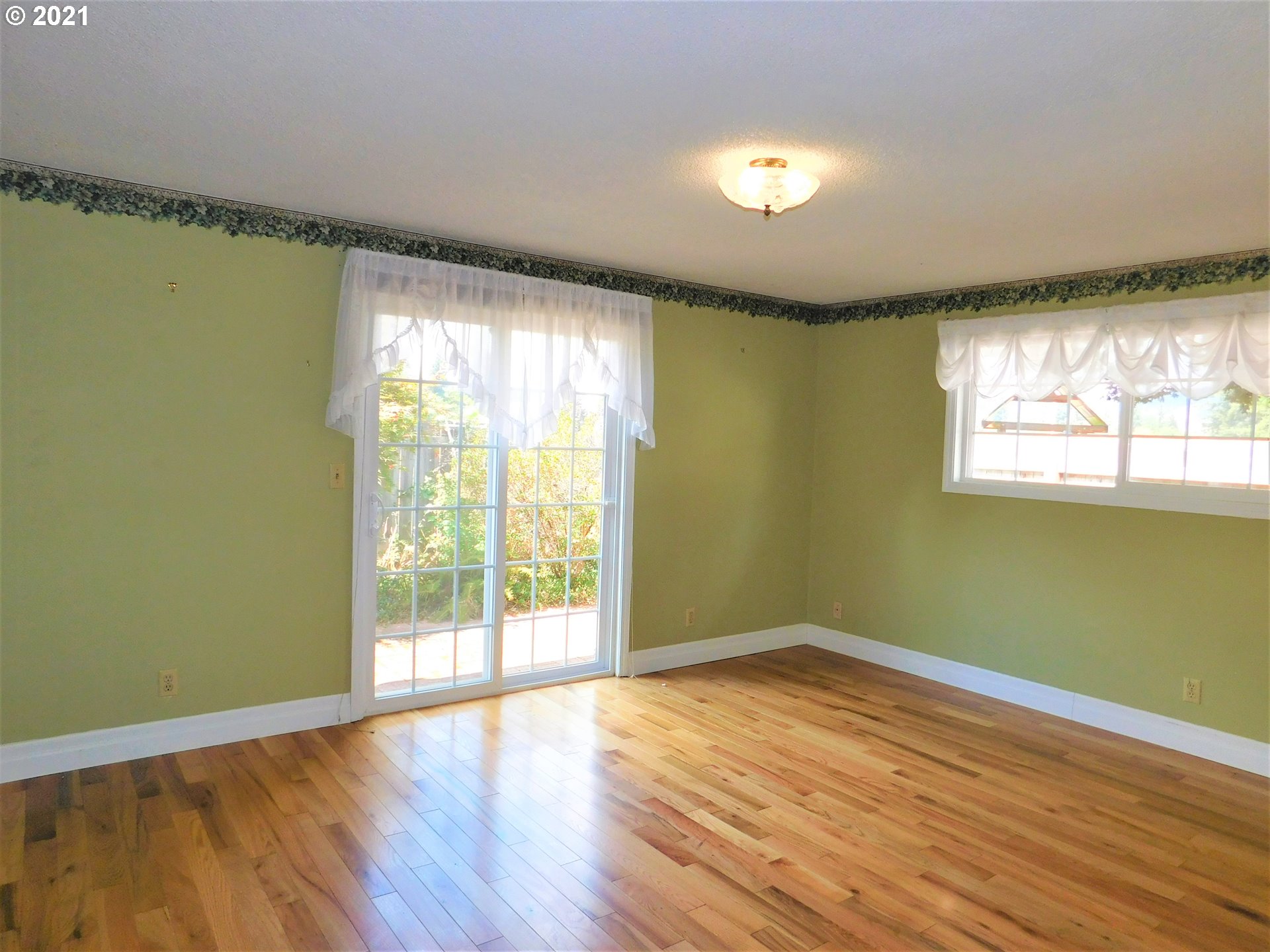 904 65th Street Springfield, OR 97478 - Photo 8 of 30 a view of empty room with wooden floor and fan