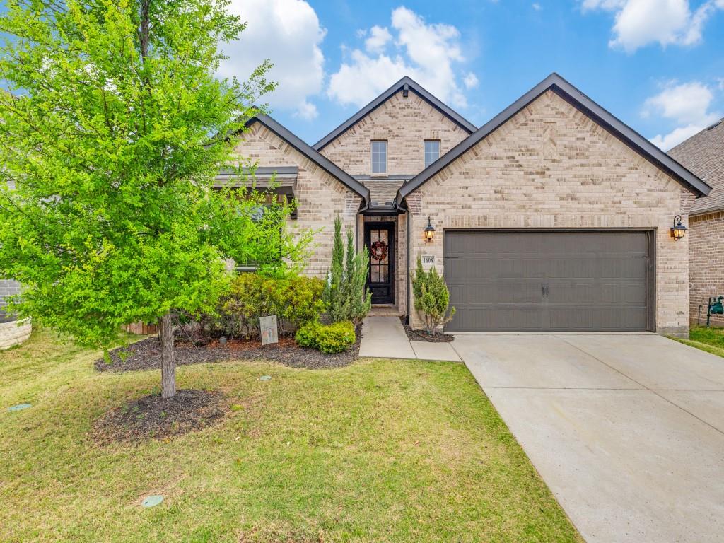 1608 Carnation Street Prosper, TX 75078 - Photo 1 of 25 a view of a house with a yard plants and large tree