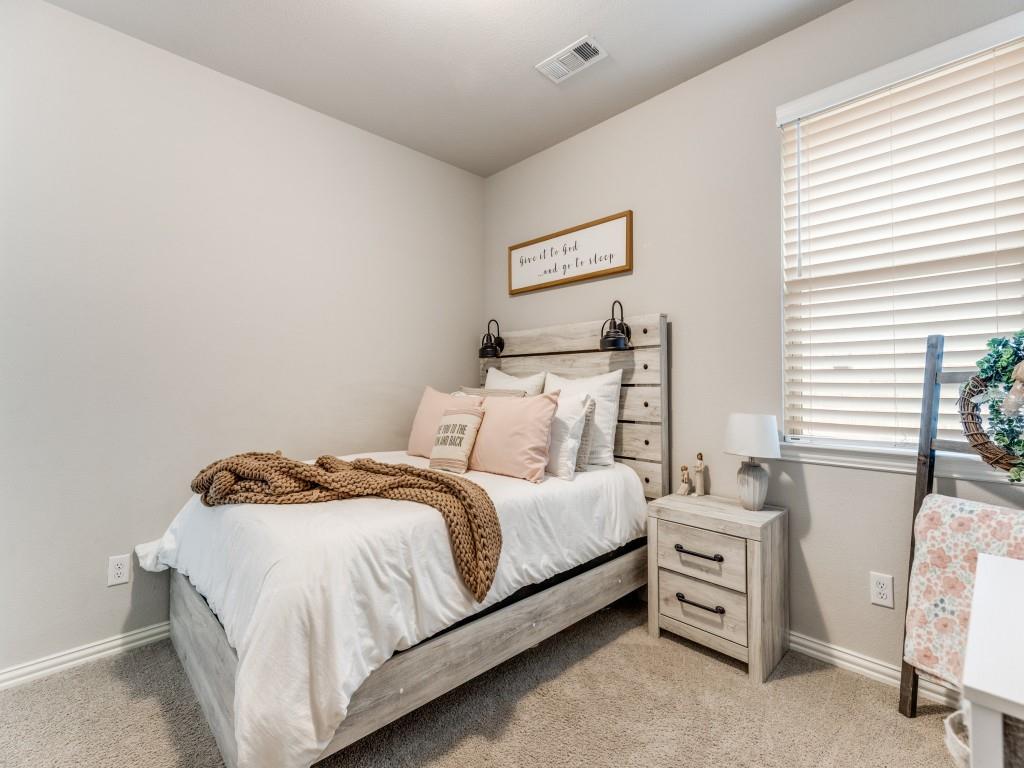 1608 Carnation Street Prosper, TX 75078 - Photo 20 of 25 a bedroom with a bed and a chair