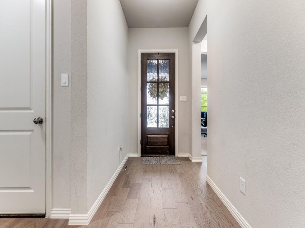 1608 Carnation Street Prosper, TX 75078 - Photo 3 of 25 a view of an empty room with wooden floor and a window