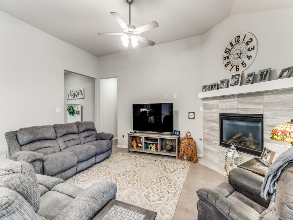 1608 Carnation Street Prosper, TX 75078 - Photo 6 of 25 a living room with furniture a flat screen tv and a fireplace
