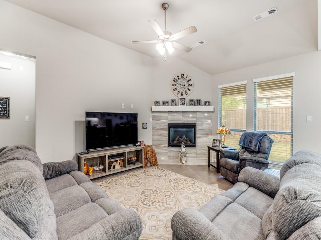 1608 Carnation Street Prosper, TX 75078 - Photo 7 of 25 a living room with furniture a flat screen tv and a fireplace
