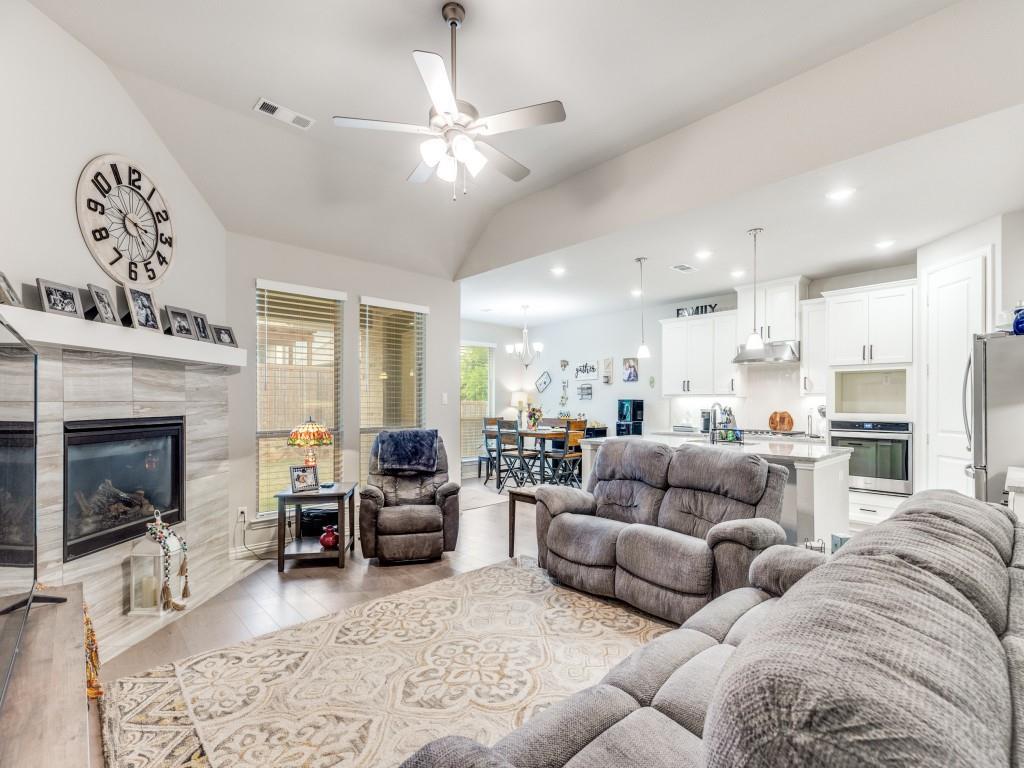 1608 Carnation Street Prosper, TX 75078 - Photo 8 of 25 a living room with furniture and a fireplace