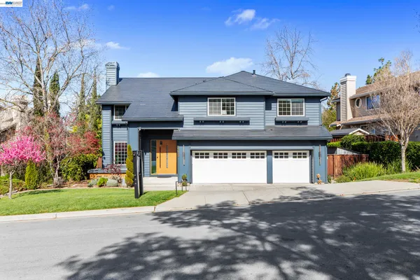 a front view of a house with a yard and a garage