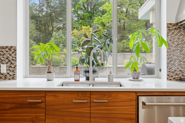 1389 Millbrook Way Bountiful, UT 84010 - Photo 27 of 74 Kitchen sink with a contemporary stainless steel faucet and undermount basin, set within a white countertop
