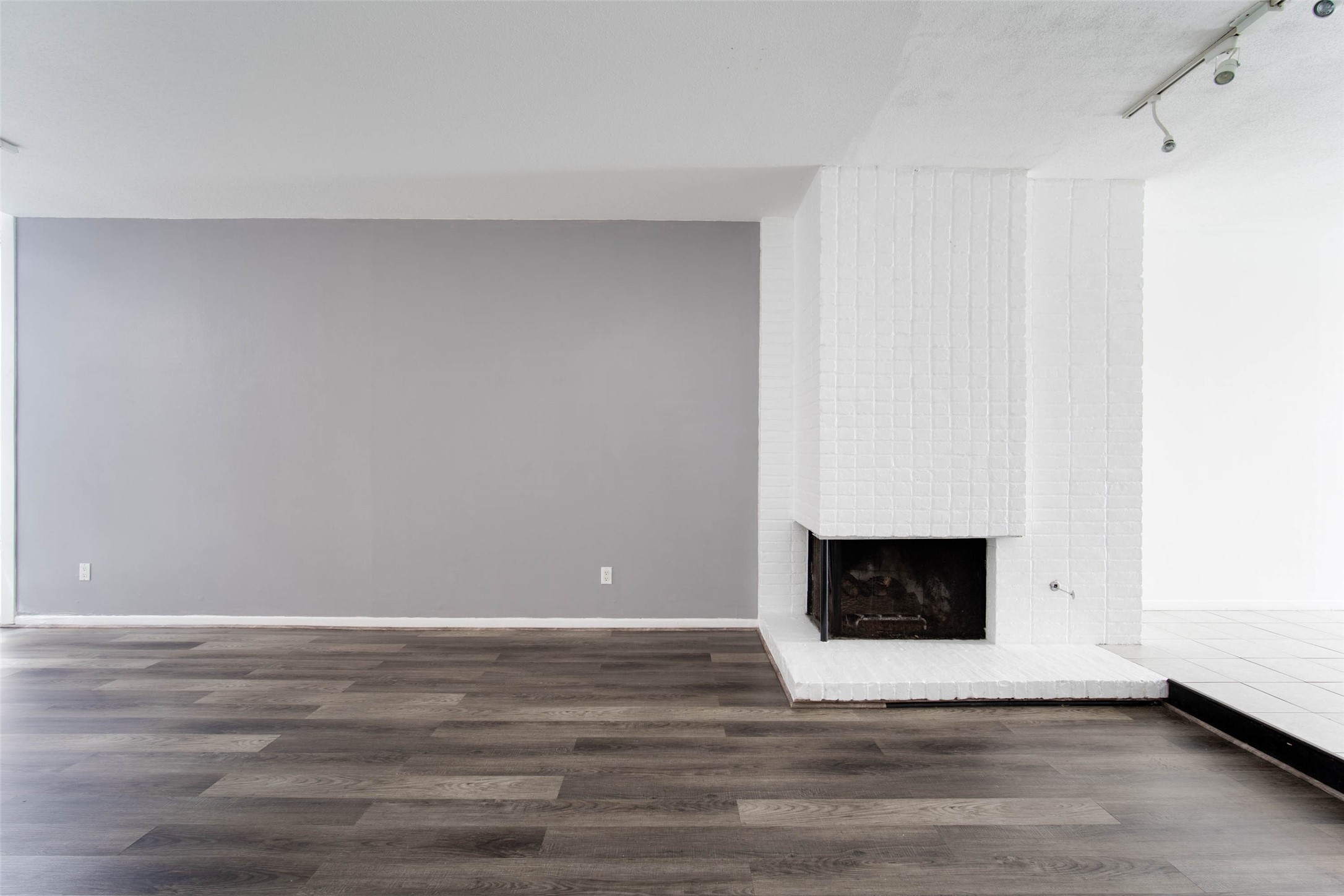 6311 Riverview Way Houston, TX 77057 - Photo 11 of 35 a view of an empty room with wooden floor and a fireplace