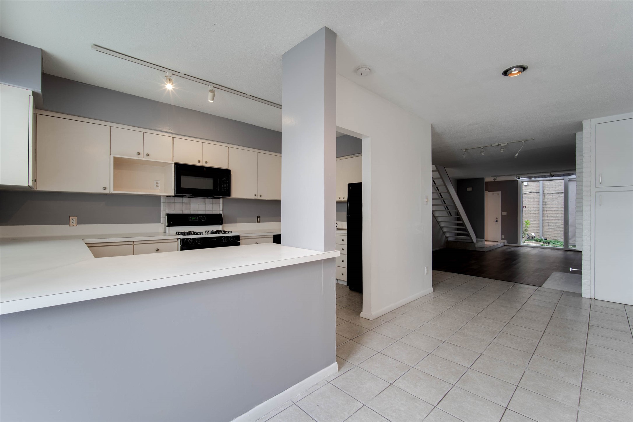6311 Riverview Way Houston, TX 77057 - Photo 17 of 35 a kitchen with stainless steel appliances a stove microwave and sink