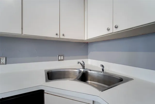 a kitchen with a sink and cabinets