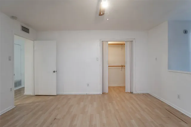 a view of an empty room and wooden floor