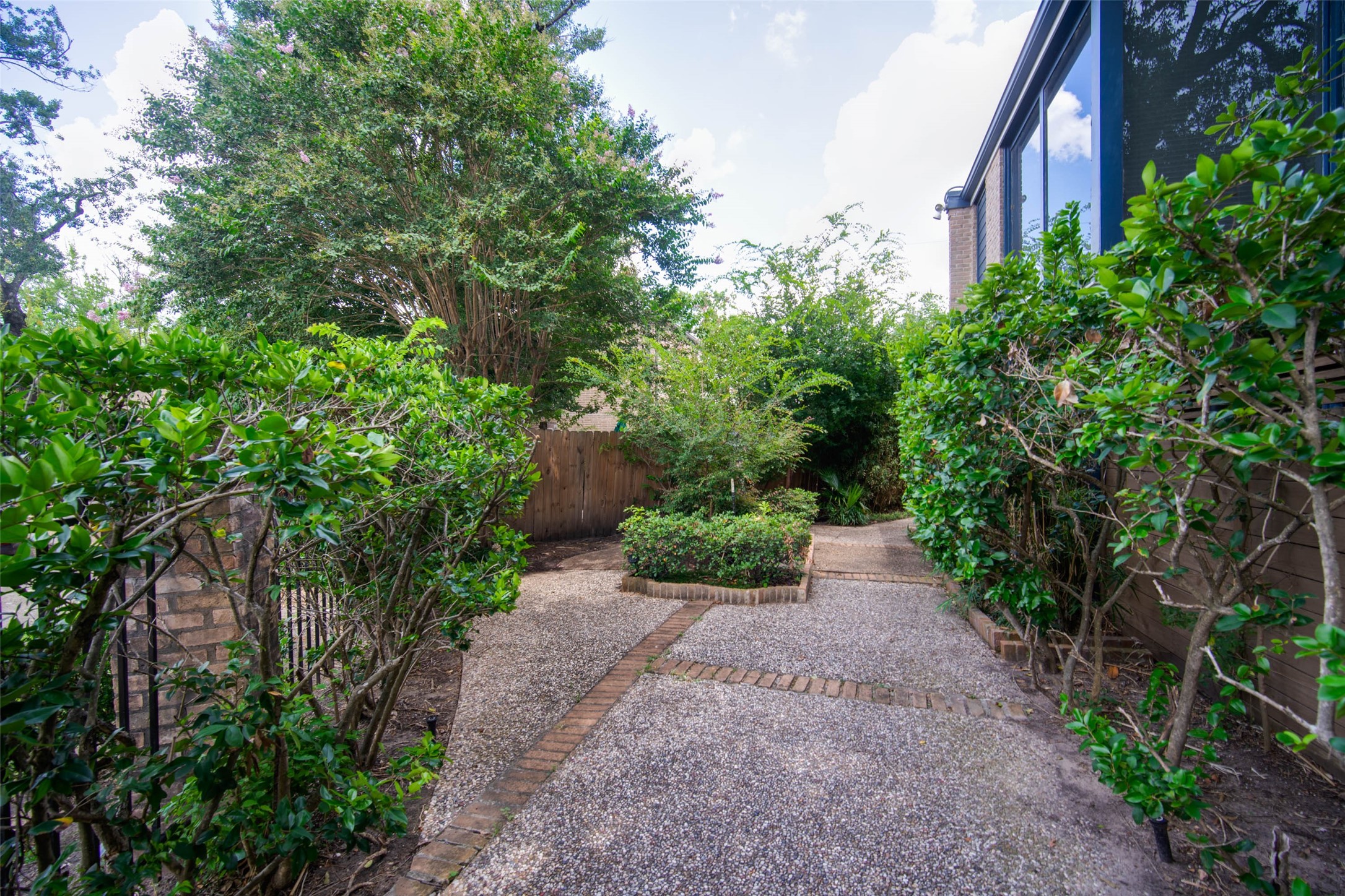 6311 Riverview Way Houston, TX 77057 - Photo 3 of 35 a view of a pathway with plants and large trees