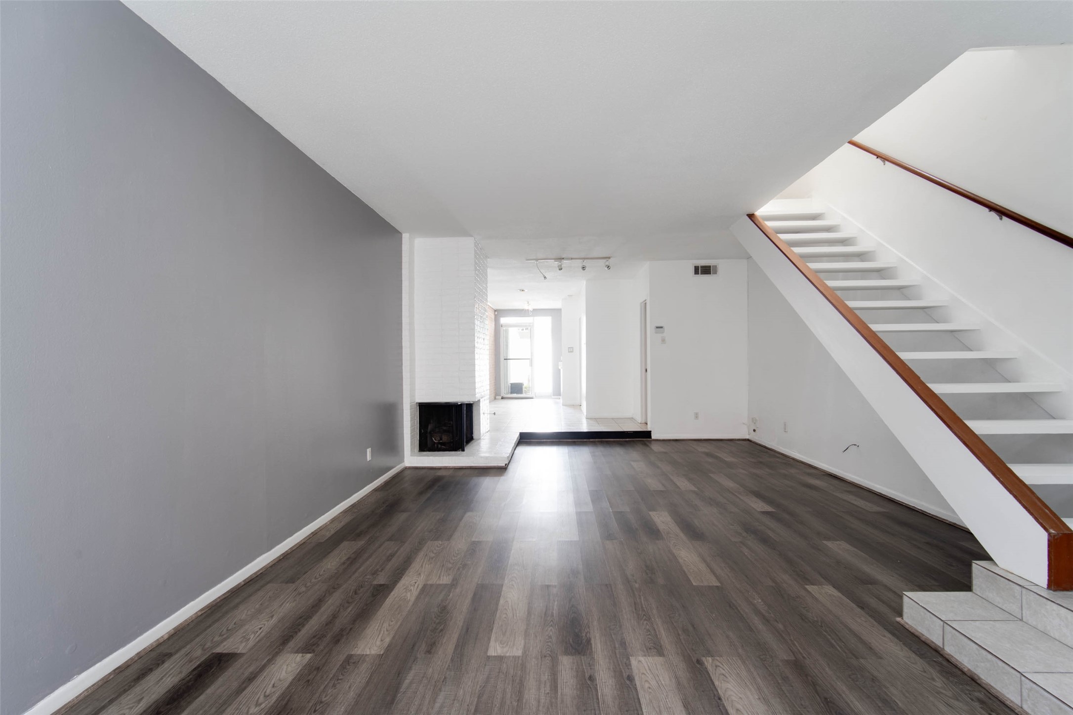 6311 Riverview Way Houston, TX 77057 - Photo 9 of 35 a view of an empty room with wooden floor and stairs