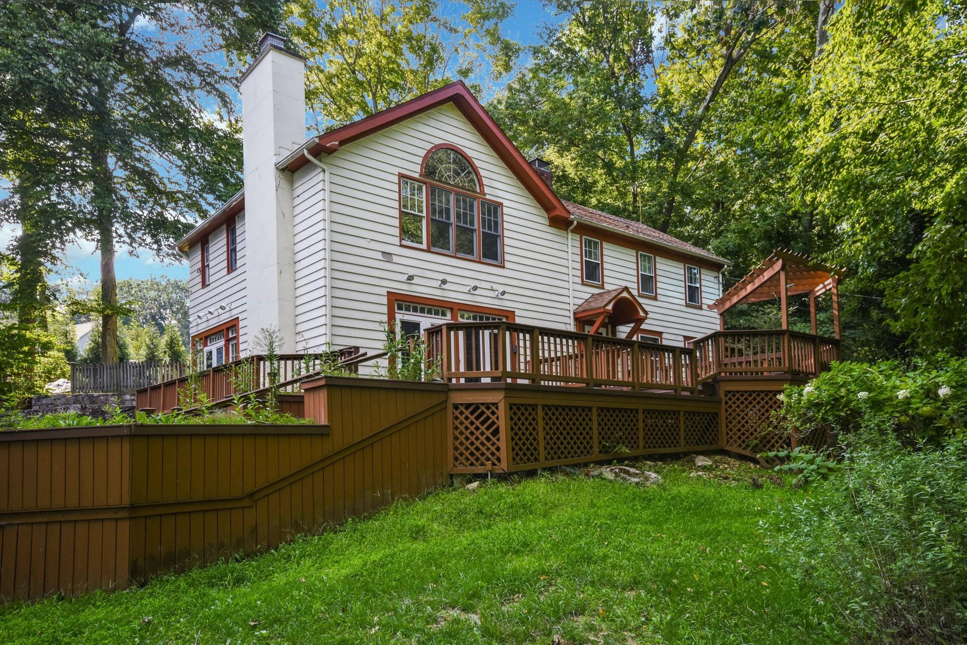 221 Mill Road New Canaan, CT 06840 - Photo 1 of 32 a view of a house with backyard and sitting area
