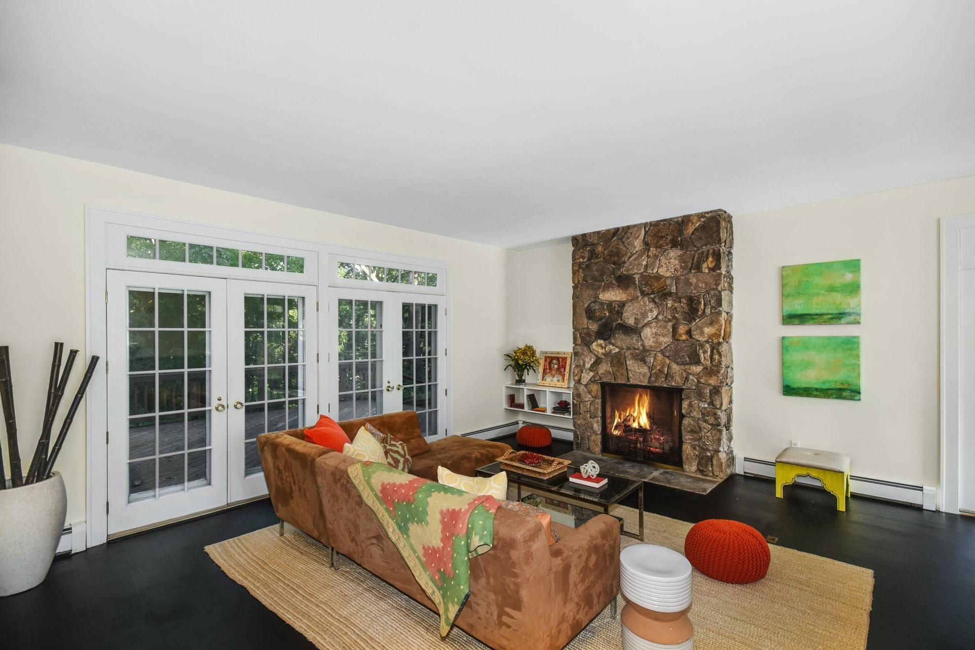 221 Mill Road New Canaan, CT 06840 - Photo 15 of 32 a living room with furniture fireplace and a large window