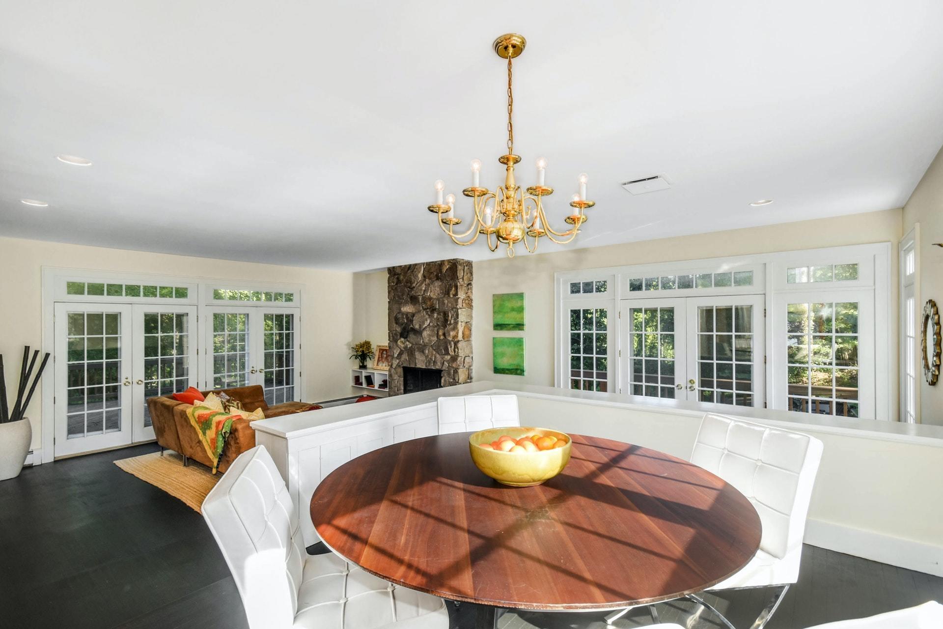 221 Mill Road New Canaan, CT 06840 - Photo 20 of 32 a view of a dining room with furniture wooden floor and chandelier