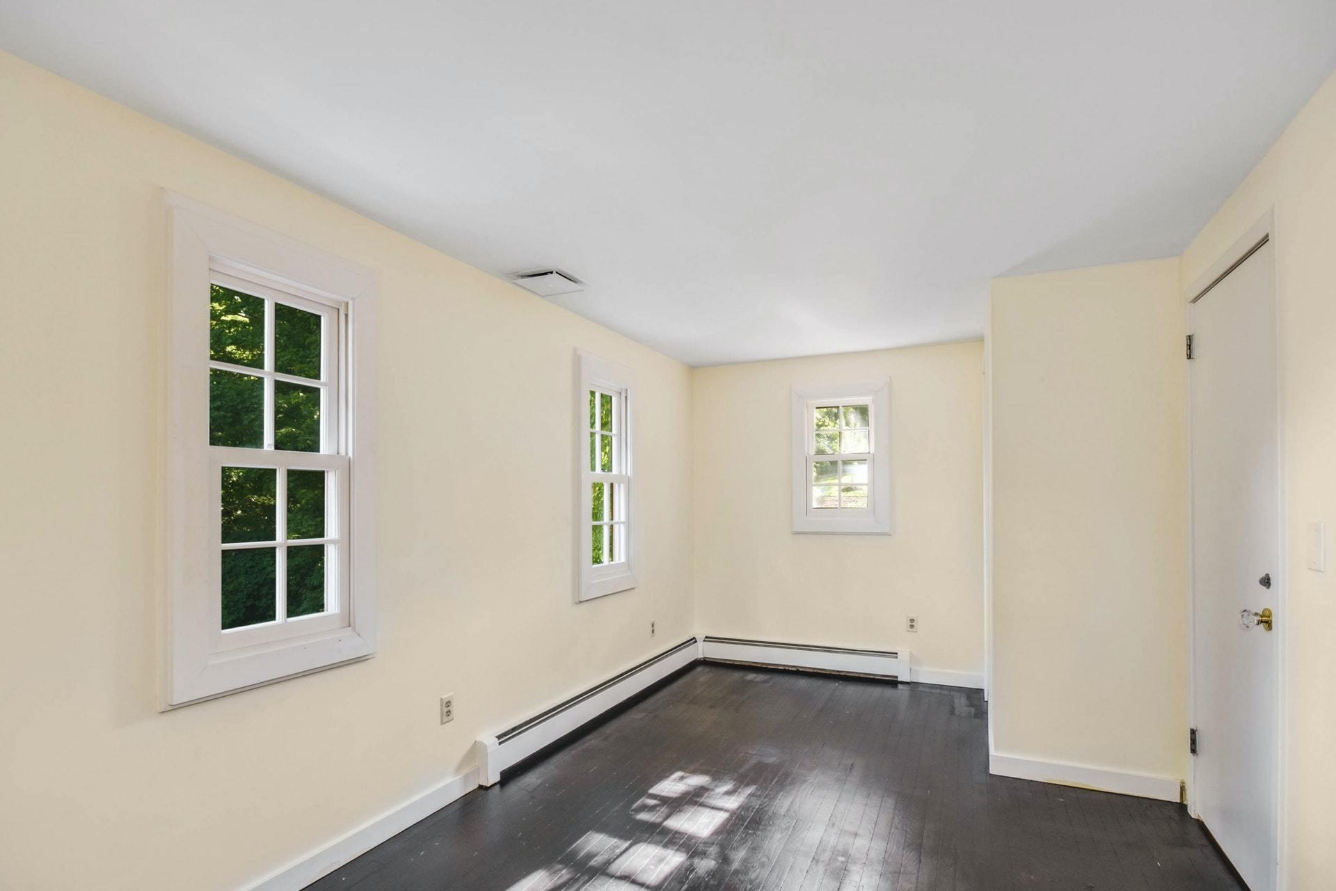 221 Mill Road New Canaan, CT 06840 - Photo 22 of 32 an empty room with windows
