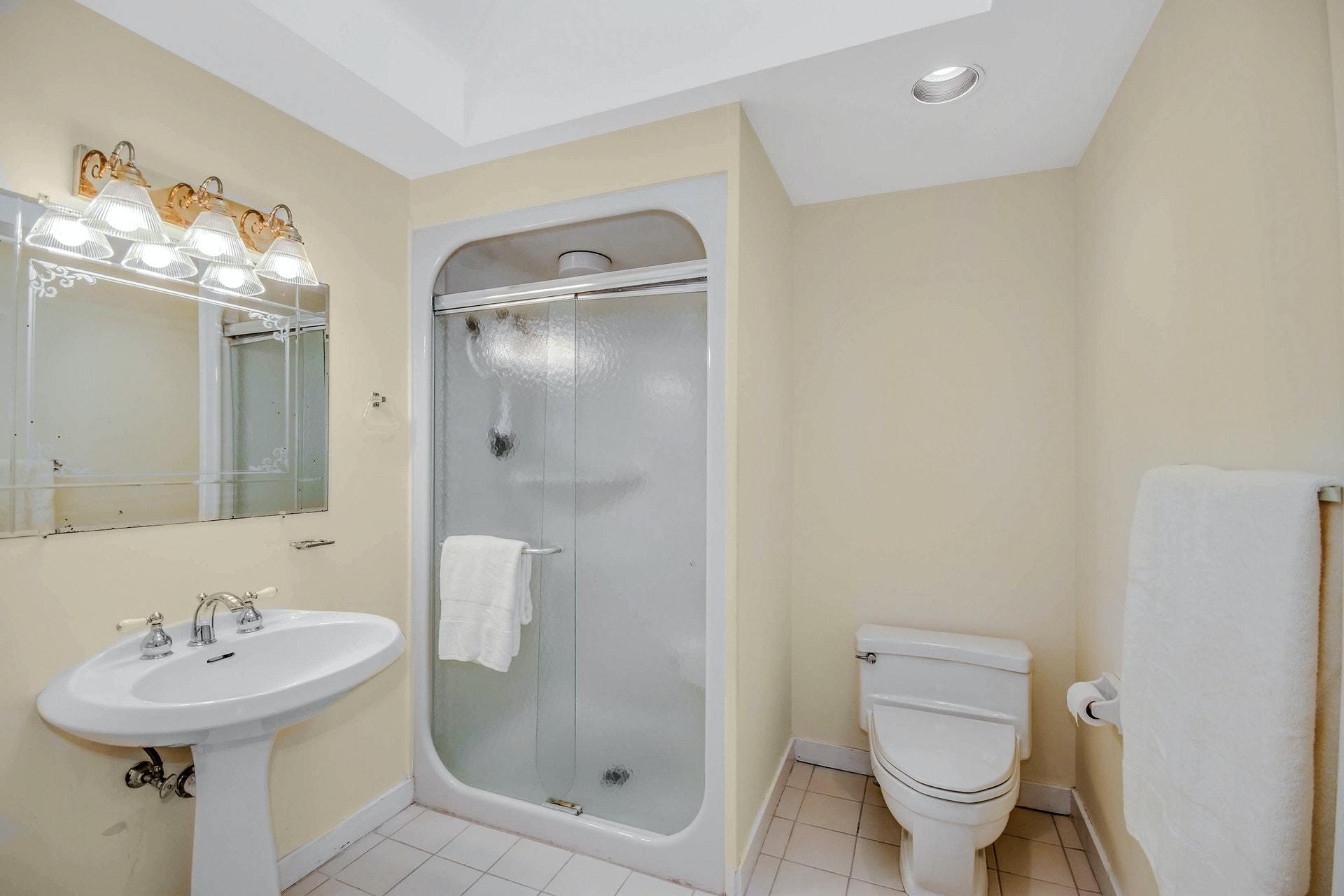 221 Mill Road New Canaan, CT 06840 - Photo 23 of 32 a bathroom with a sink toilet and shower