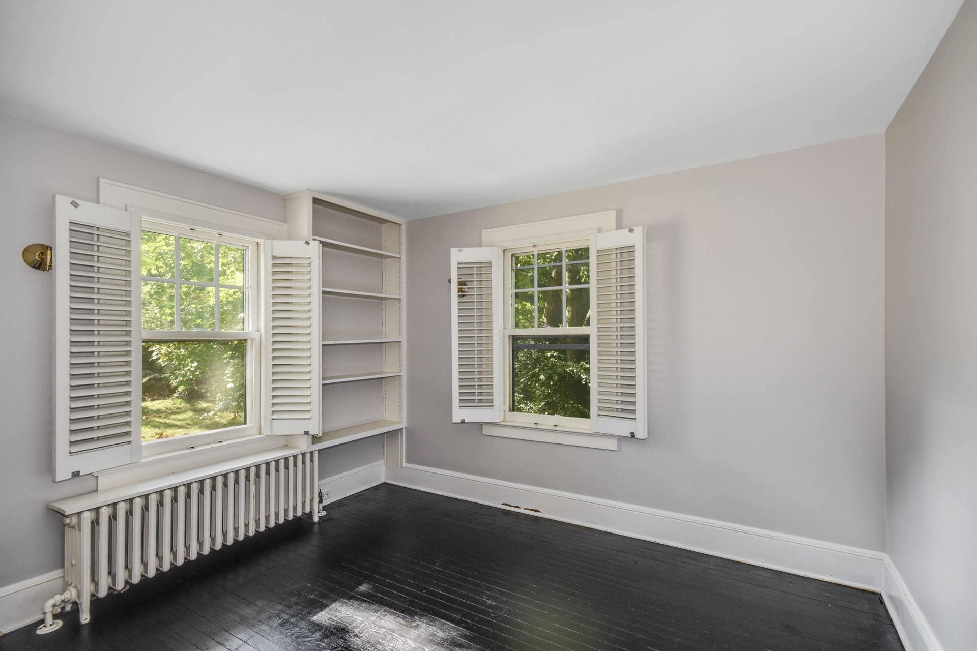 221 Mill Road New Canaan, CT 06840 - Photo 24 of 32 an empty room with wooden floor and windows