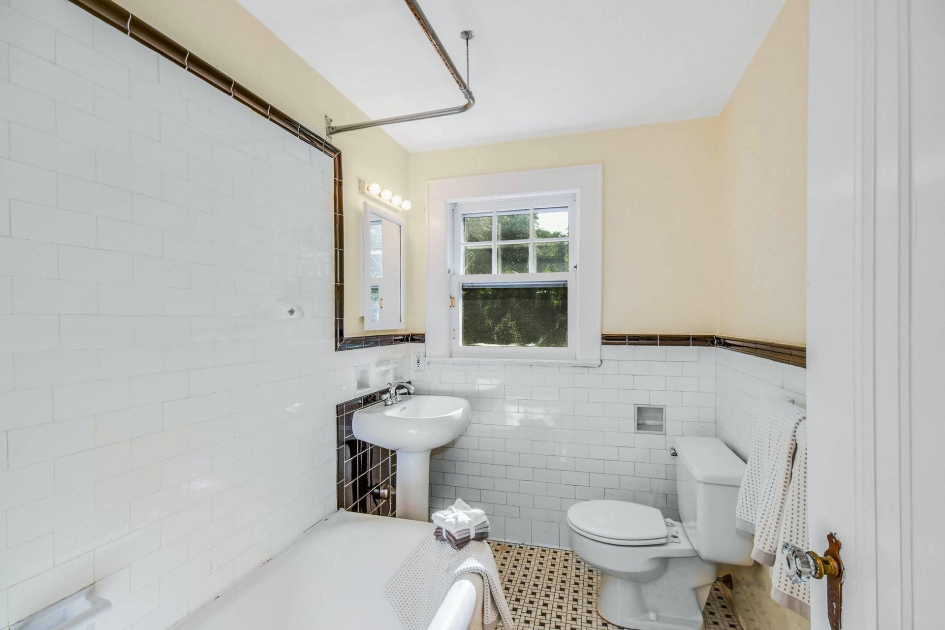 221 Mill Road New Canaan, CT 06840 - Photo 27 of 32 a bathroom with a toilet sink and mirror