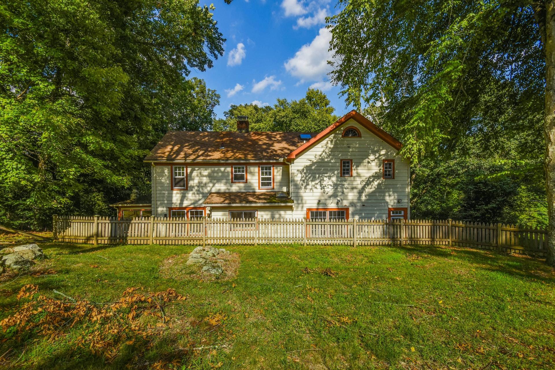 221 Mill Road New Canaan, CT 06840 - Photo 29 of 32 a view of a house with a big yard