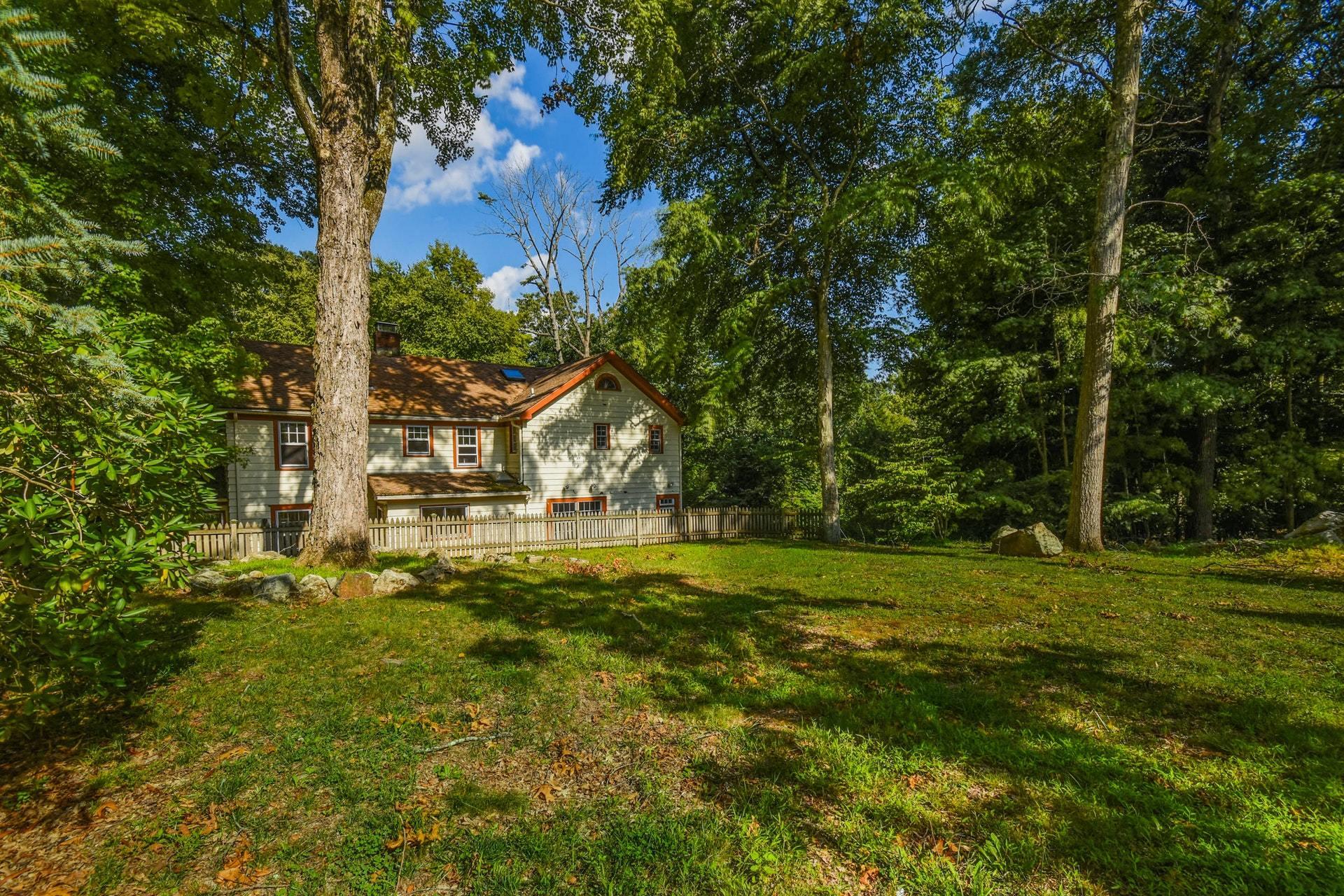 221 Mill Road New Canaan, CT 06840 - Photo 30 of 32 a view of a house with a big yard