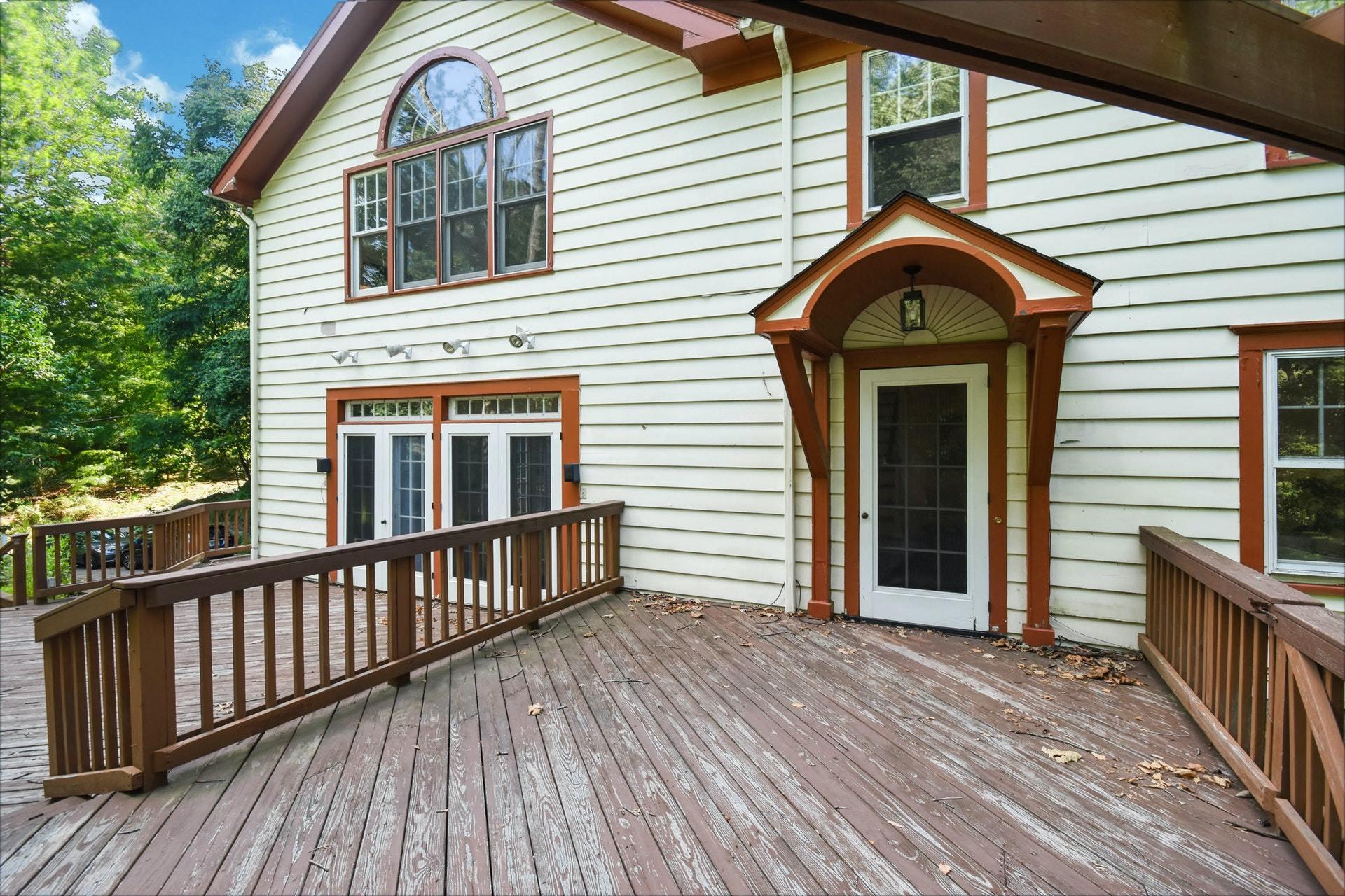 221 Mill Road New Canaan, CT 06840 - Photo 4 of 32 a front view of a house with balcony