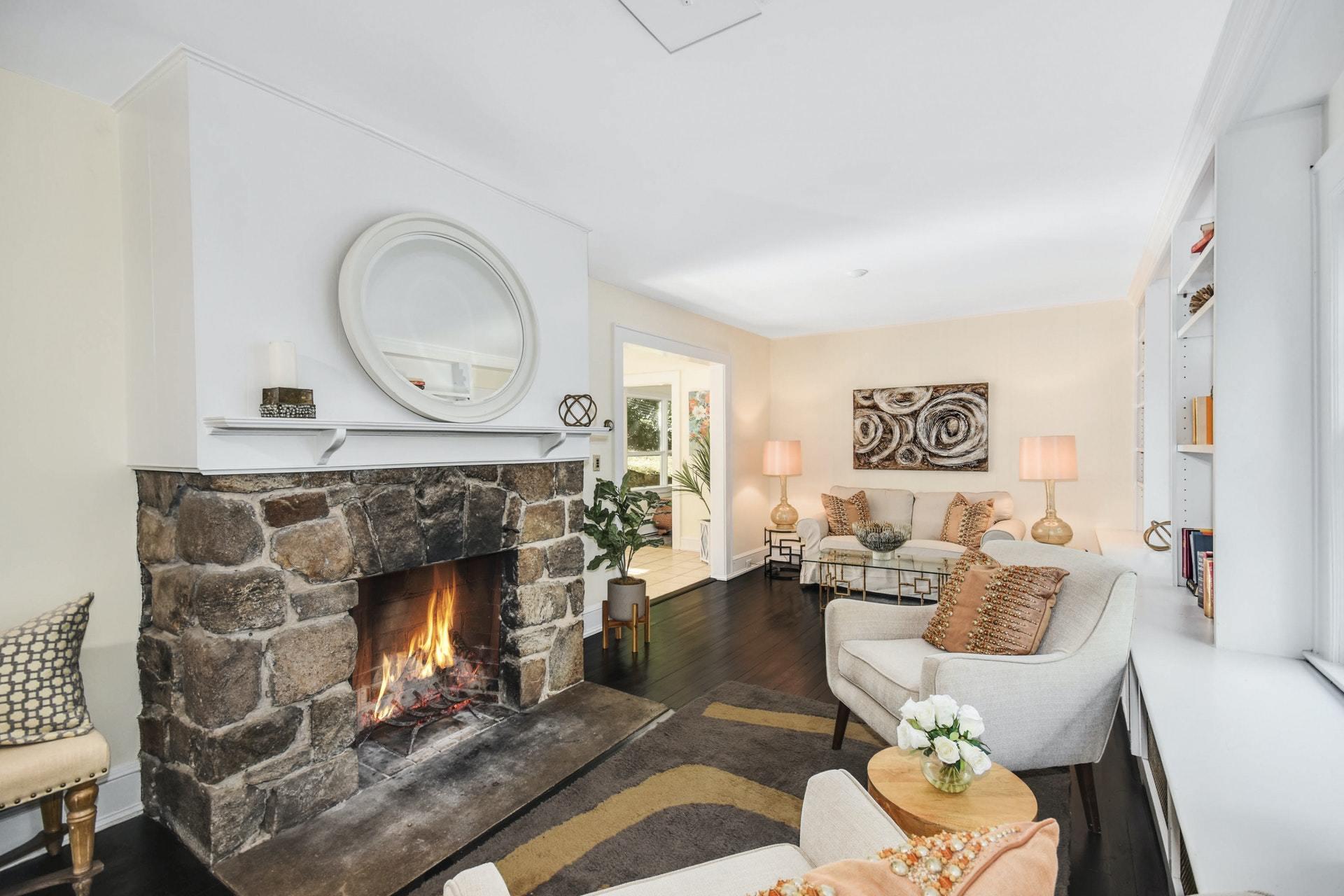 221 Mill Road New Canaan, CT 06840 - Photo 6 of 32 a living room with furniture a mirror and a fireplace
