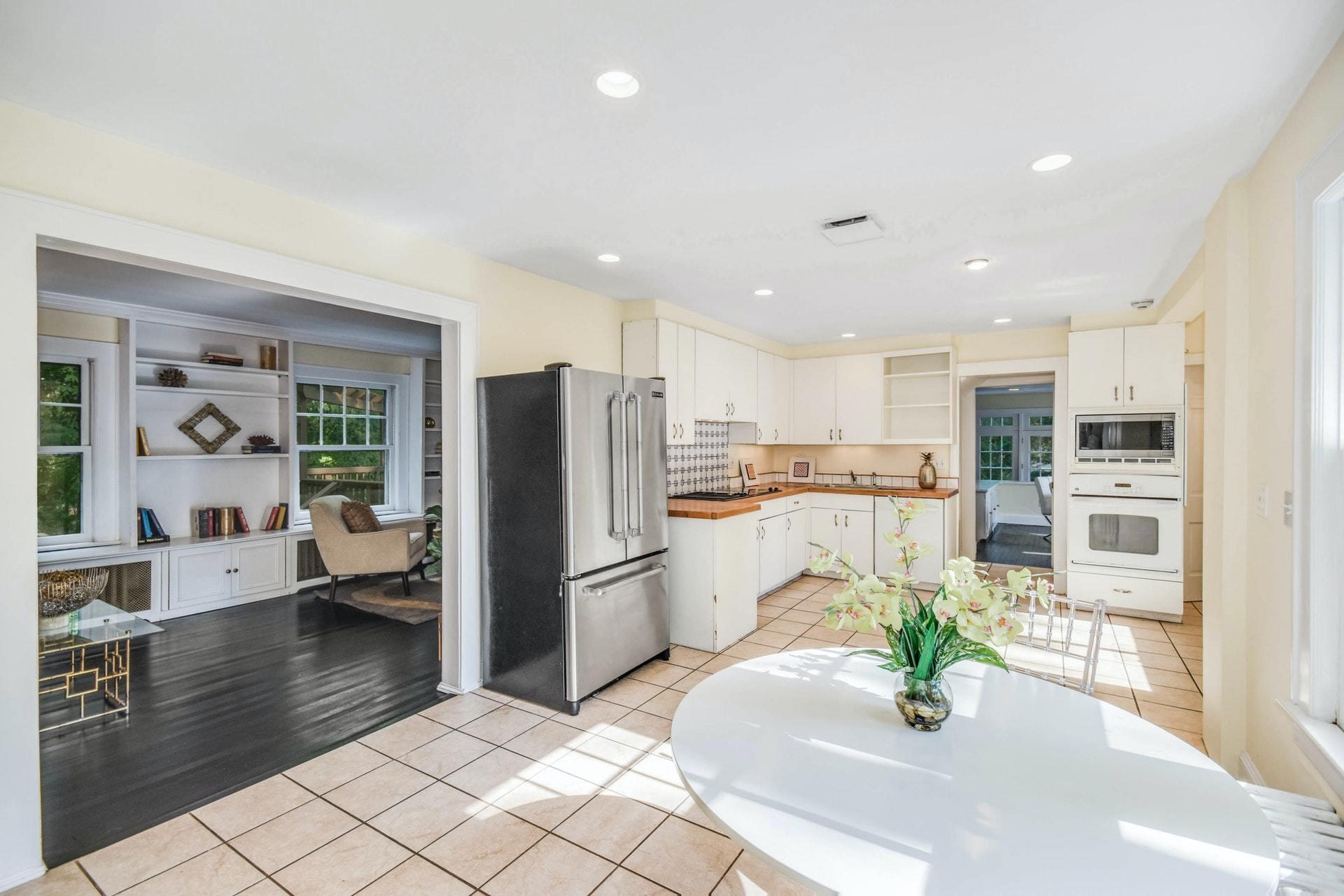 221 Mill Road New Canaan, CT 06840 - Photo 9 of 32 a kitchen with stainless steel appliances kitchen island granite countertop a refrigerator a stove a oven and white cabinets with wooden floor
