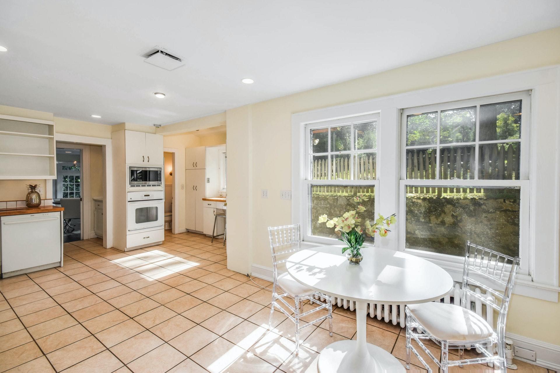 221 Mill Road New Canaan, CT 06840 - Photo 10 of 32 a view of a living room and kitchen with a large window
