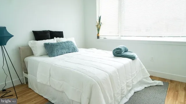 a bedroom with a bed and window