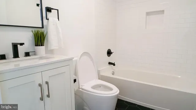a bathroom with a sink a toilet and a bathtub