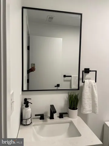a bathroom with a sink and mirror