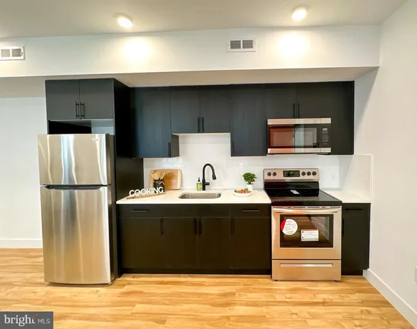 a kitchen with a sink a stove and refrigerator