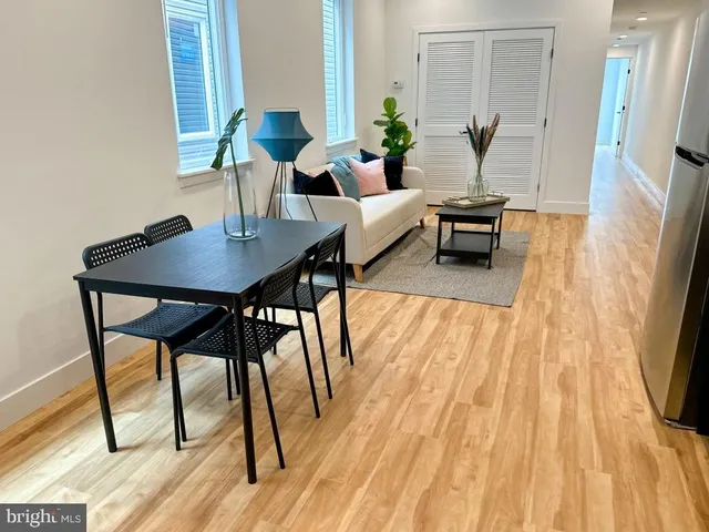 a view of a dining room with furniture and wooden floor