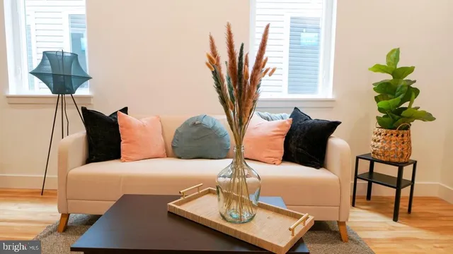 a bedroom with a bed a lamp and a potted plant