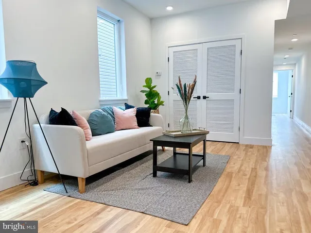 a living room with furniture and a wooden floor