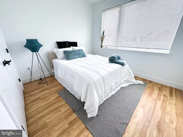 a bedroom with a bed and window