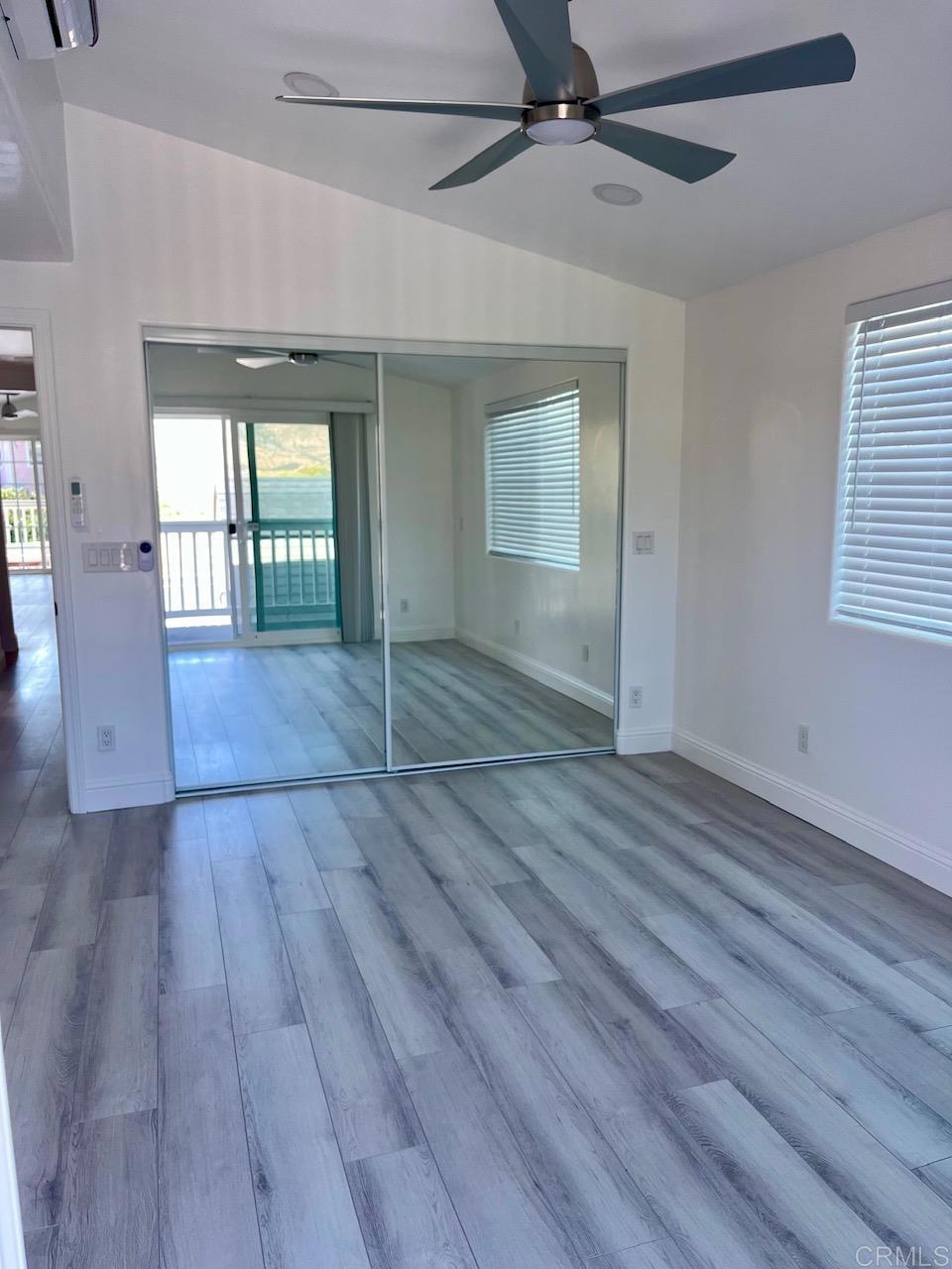 9902 Jamacha Boulevard, Unit 160 Spring Valley, CA 91977 - Photo 7 of 18 an empty room with wooden floor and windows
