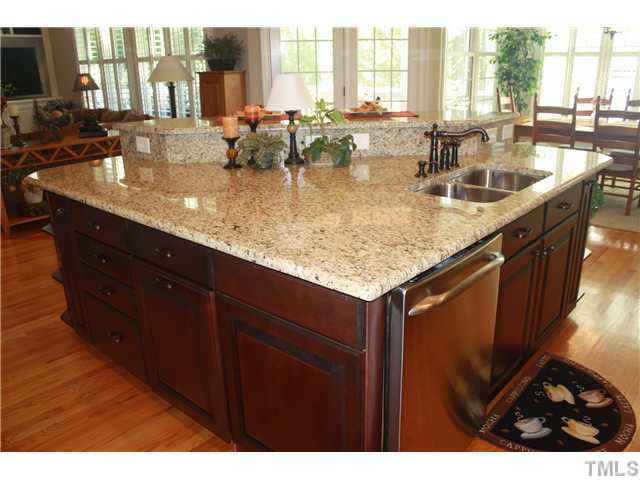 2812 Winter Song Road Raleigh, NC 27614 - Photo 10 of 24 This large center island is the focal point of this elegant kitchen, and is graced with gleaming granite counter-tops & beautifully stained, raised panel cabinets. Oil rubbed bronze fixtures & hardware add a touch of elegance to this working kitchen.